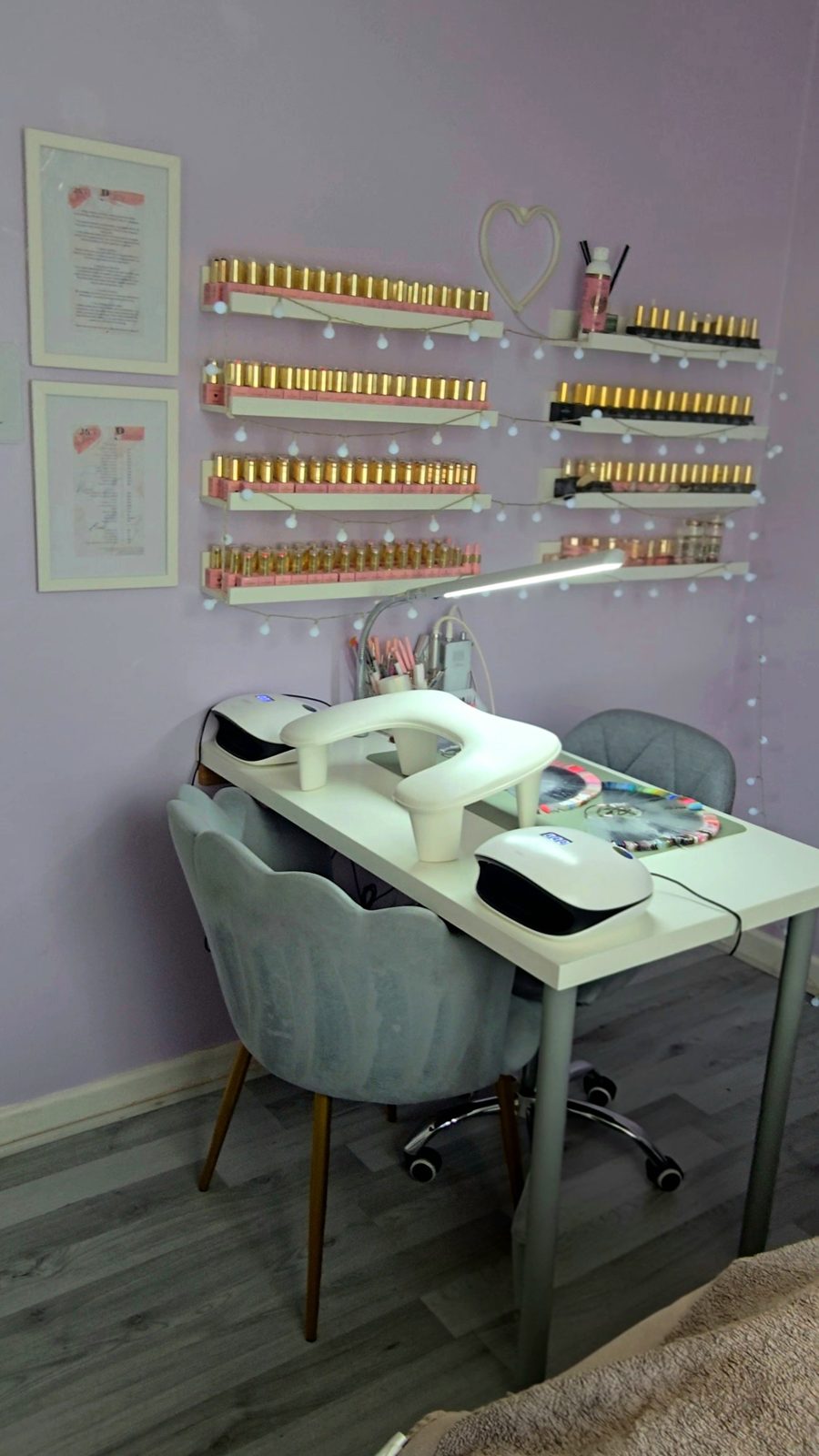 Jess's nail desk with a wall of gel colours